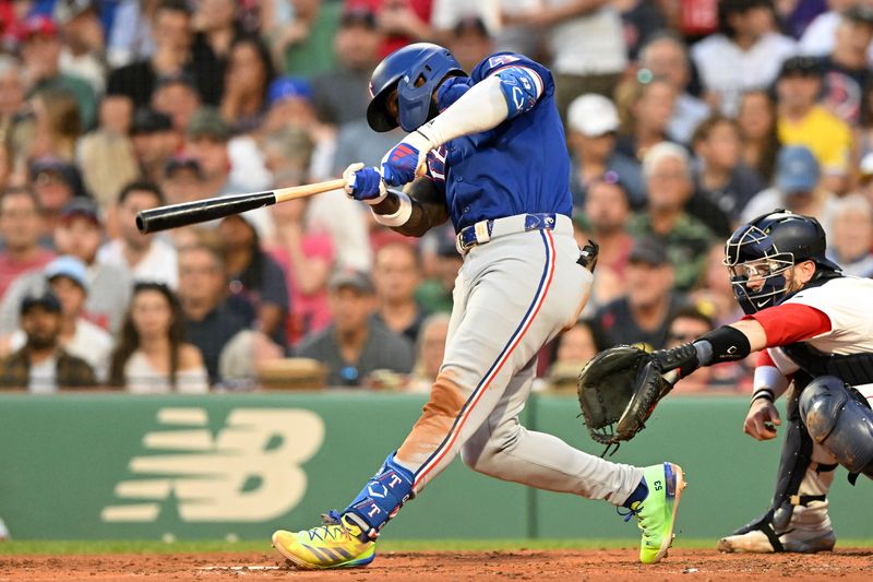 Aug 14, 2024; Boston, Massachusetts, USA; Texas Rangers designated hitter Adolis Garcia (53) hits a solo home run against the Boston Red Sox during the sixth inning at Fenway Park. Mandatory Credit: Brian Fluharty-USA TODAY Sports