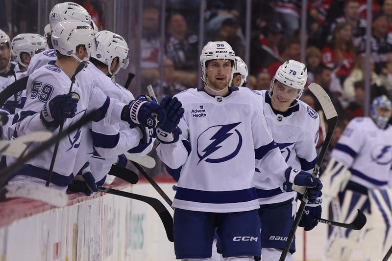 Oct 22, 2024; Newark, New Jersey, USA; Tampa Bay Lightning defenseman Janis Moser (90) celebrates his goal against the New Jersey Devils during the third period at Prudential Center. Mandatory Credit: Ed Mulholland-Imagn Images