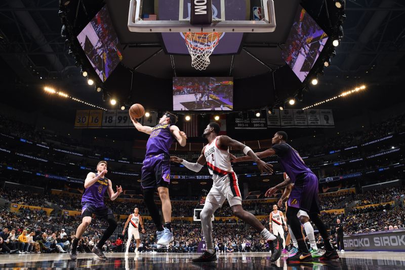 LOS ANGELES, CA - JANUARY 2: Austin Reaves #15 of the Los Angeles Lakers rebounds the ball during the game against the Portland Trail Blazers on January 2, 2025 at Crypto.Com Arena in Los Angeles, California. NOTE TO USER: User expressly acknowledges and agrees that, by downloading and/or using this Photograph, user is consenting to the terms and conditions of the Getty Images License Agreement. Mandatory Copyright Notice: Copyright 2025 NBAE (Photo by Adam Pantozzi/NBAE via Getty Images)