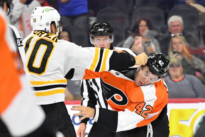 Sep 24, 2022; Philadelphia, Pennsylvania, USA; Boston Bruins left wing A.J. Greer (10) and Philadelphia Flyers right wing Hayden Hodgson (42) fight during the second period at Wells Fargo Center. Mandatory Credit: Eric Hartline-USA TODAY Sports