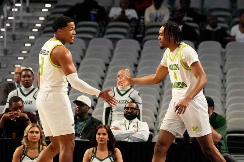 Mar 16, 2024; Fort Worth, TX, USA;  South Florida Bulls guard Kobe Knox (4) celebrates with South Florida Bulls guard Chris Youngblood (3) after scoring a three point basket against the UAB Blazers during the first half at Dickies Arena. Mandatory Credit: Chris Jones-USA TODAY Sports