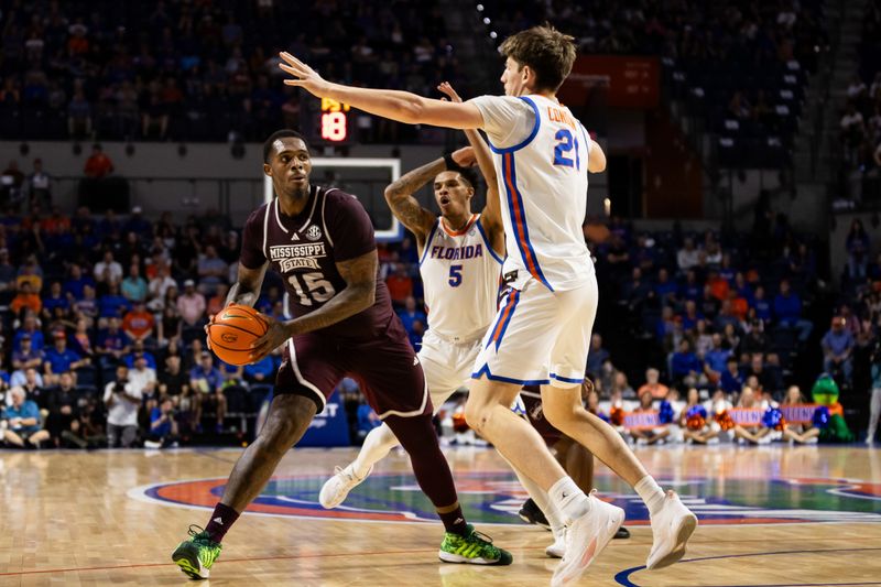 Jan 24, 2024; Gainesville, Florida, USA; Mississippi State Bulldogs forward Jimmy Bell Jr. (15) looks to pass around Florida Gators forward Alex Condon (21) during the first half at Exactech Arena at the Stephen C. O'Connell Center. Mandatory Credit: Matt Pendleton-USA TODAY Sports