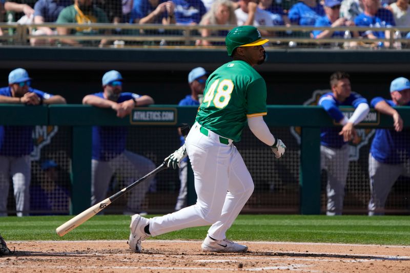 Mar 10, 2024; Mesa, Arizona, USA; Oakland Athletics shortstop Darell Hernaiz (48) hits an RBI single against the Kansas City Royals in the second inning at Hohokam Stadium. Mandatory Credit: Rick Scuteri-USA TODAY Sports