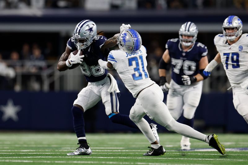 Dallas Cowboys wide receiver CeeDee Lamb (88) stiff arms a defender as he carries the ball after a reception during an NFL football game against the Detroit Lions, Saturday, Dec. 30, 2023, in Arlington, Texas. (AP Photo/Matt Patterson)