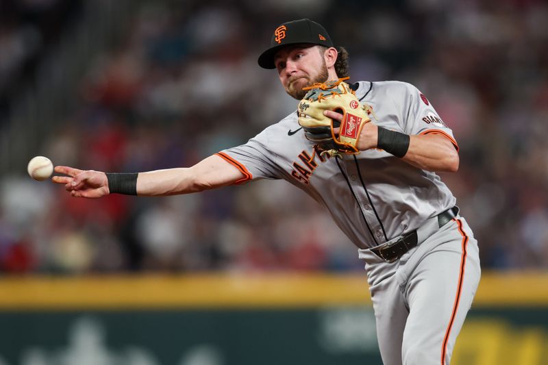 Jul 2, 2024; Atlanta, Georgia, USA; San Francisco Giants second baseman Brett Wisely (0) throws a runner out at first against the Atlanta Braves in the eighth inning at Truist Park. Mandatory Credit: Brett Davis-USA TODAY Sports