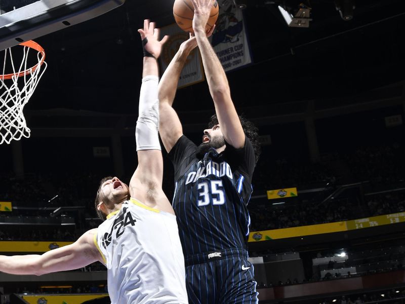 ORLANDO, FL - JANUARY 5 :  Goga Bitadze #35 of the Orlando Magic drives to the basket during the game against the Utah Jazz on January 5, 2025 at Kia Center in Orlando, Florida. NOTE TO USER: User expressly acknowledges and agrees that, by downloading and or using this photograph, User is consenting to the terms and conditions of the Getty Images License Agreement. Mandatory Copyright Notice: Copyright 2025 NBAE (Photo by Fernando Medina/NBAE via Getty Images)