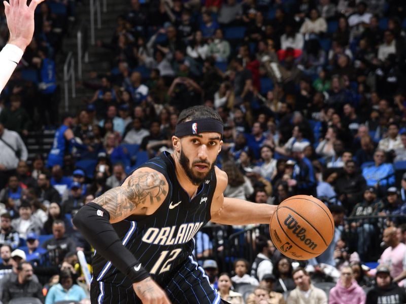 ORLANDO, FL - JANUARY 5 : Trevelin Queen #12 of the Orlando Magic dribbles the ball during the game against the Utah Jazz  on January 5, 2025 at Kia Center in Orlando, Florida. NOTE TO USER: User expressly acknowledges and agrees that, by downloading and or using this photograph, User is consenting to the terms and conditions of the Getty Images License Agreement. Mandatory Copyright Notice: Copyright 2025 NBAE (Photo by Fernando Medina/NBAE via Getty Images)