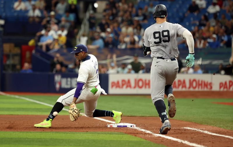 May 10, 2024; St. Petersburg, Florida, USA;  Tampa Bay Rays first base Yandy Díaz (2) forces out New York Yankees outfielder Aaron Judge (99) during the eighth inning at Tropicana Field. Mandatory Credit: Kim Klement Neitzel-USA TODAY Sports