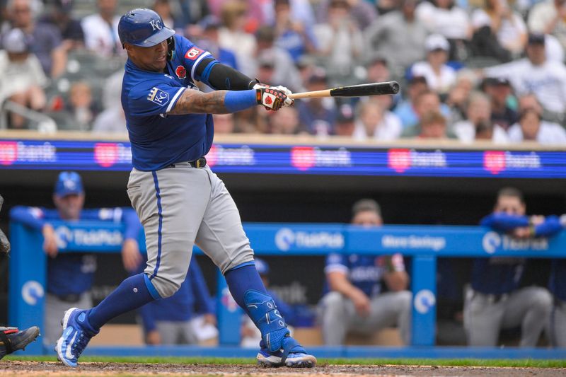 May 27, 2024; Minneapolis, Minnesota, USA; Kansas City Royals catcher Salvador Perez (13) hits a single against the Minnesota Twins during the ninth inning at Target Field. Mandatory Credit: Nick Wosika-USA TODAY Sports