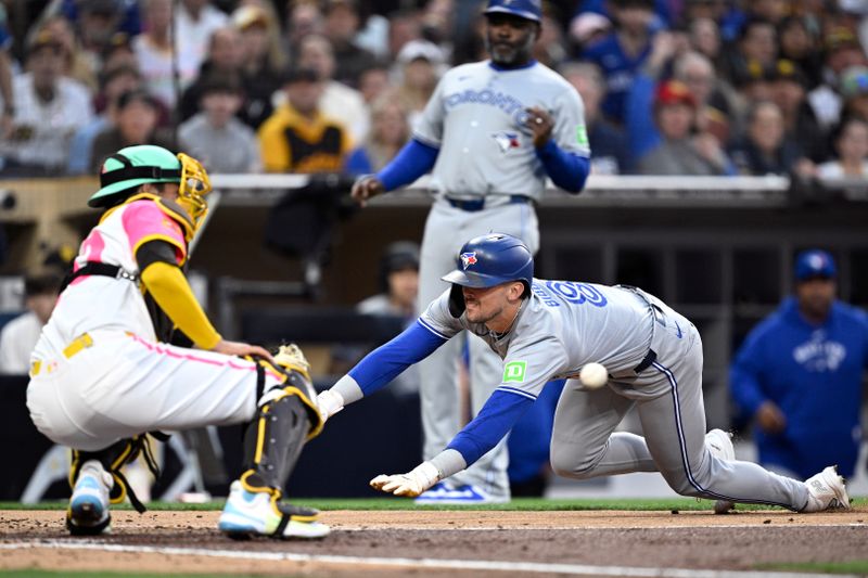 Apr 19, 2024; San Diego, California, USA; Toronto Blue Jays right fielder Cavan Biggio (8) slides home to score a run ahead of the throw to San Diego Padres catcher Kyle Higashioka (20) during the second inning at Petco Park. Mandatory Credit: Orlando Ramirez-USA TODAY Sports 
