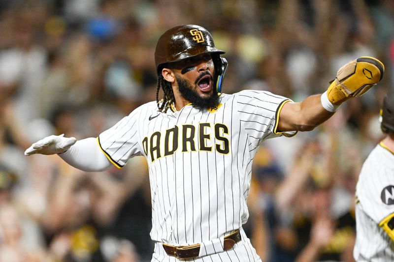 Sep 4, 2024; San Diego, California, USA; San Diego Padres right fielder Fernando Tatis Jr. (23) celebrates as he scores during the fifth inning against the Detroit Tigers at Petco Park. Mandatory Credit: Denis Poroy-Imagn Images