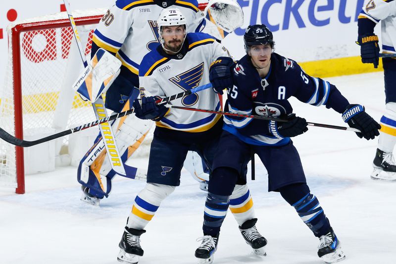 Feb 27, 2024; Winnipeg, Manitoba, CAN; St. Louis Blues defenseman Justin Faulk (72) jostles for position with Winnipeg Jets forward Mark Scheifele (55) in front of St. Louis Blues goalie Joel Hofer (30) during the third period at Canada Life Centre. Mandatory Credit: Terrence Lee-USA TODAY Sports