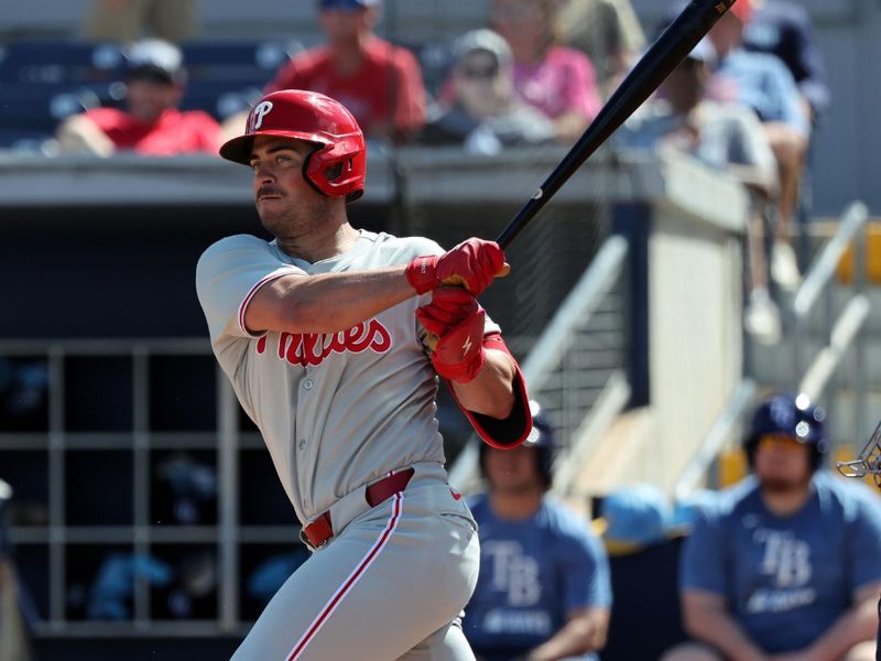 Feb 25, 2025; Port Charlotte, Florida, USA;  Philadelphia Phillies infielder Otto Kemp (82) hits a RBI double against the Tampa Bay Rays during the fourth inning at Charlotte Sports Park. Mandatory Credit: Kim Klement Neitzel-Imagn Images