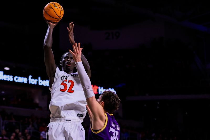 Dec 29, 2025; Cincinnati, Ohio, USA; Cincinnati Bearcats center Moustapha Thiam (52) shoots against Lipscomb Bisons guard Ross Candelino (30) in the second half at Fifth Third Arena. Mandatory Credit: Katie Stratman-Imagn Images