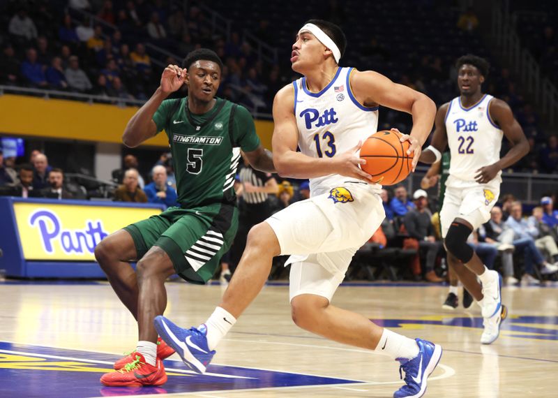 Dec 17, 2025; Pittsburgh, Pennsylvania, USA;  Pittsburgh Panthers forward Roman Siulepa (13) goes to the basket against Binghamton Bearcats guard Wes Peterson (5) during the first half at the Petersen Events Center. Mandatory Credit: Charles LeClaire-Imagn Images