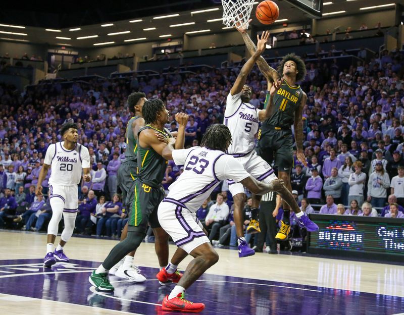 Jan 16, 2024; Manhattan, Kansas, USA; Kansas State Wildcats guard Cam Carter (5) tries to shoot against Baylor Bears forward Jalen Bridges (11) during the first half at Bramlage Coliseum. Mandatory Credit: Scott Sewell-USA TODAY Sports