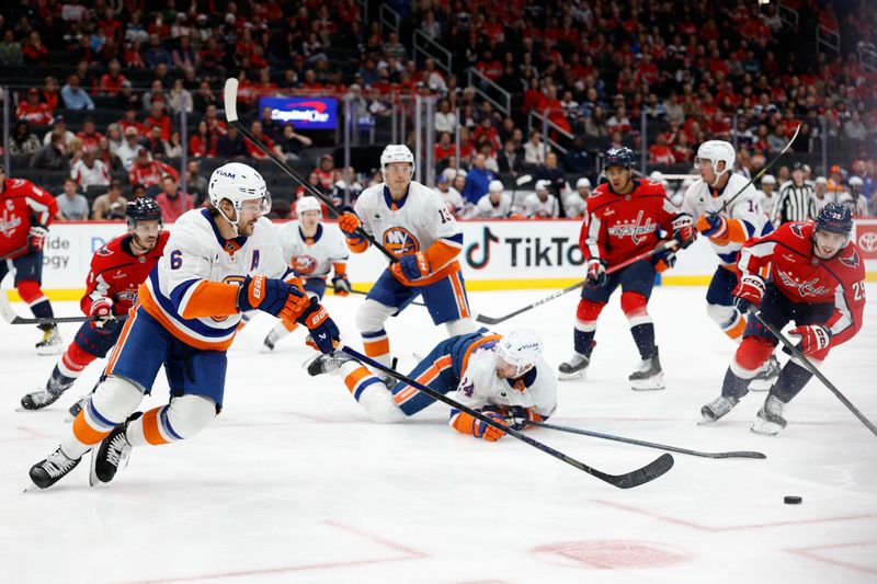 Oct 31, 2025; Washington, District of Columbia, USA; New York Islanders defenseman Ryan Pulock (6) reaches for the puck in front of Washington Capitals center Hendrix Lapierre (29) during the third period at Capital One Arena. Mandatory Credit: Geoff Burke-Imagn Images