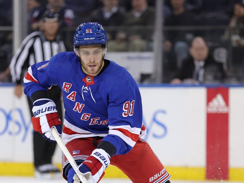 Mar 11, 2024; New York, New York, USA; New York Rangers center Alex Wennberg (91) skates with the puck against the New Jersey Devils during the third period at Madison Square Garden. Mandatory Credit: Brad Penner-USA TODAY Sports