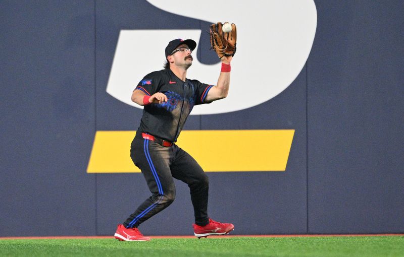 Jun 5, 2024; Toronto, Ontario, CAN;  Toronto Blue Jays left fielder Davis Schneider (36) catches a fly ball hit by Baltimore Orioles second baseman Jordan Westburg (not shown) in the ninth inning at Rogers Centre. Mandatory Credit: Dan Hamilton-USA TODAY Sports 