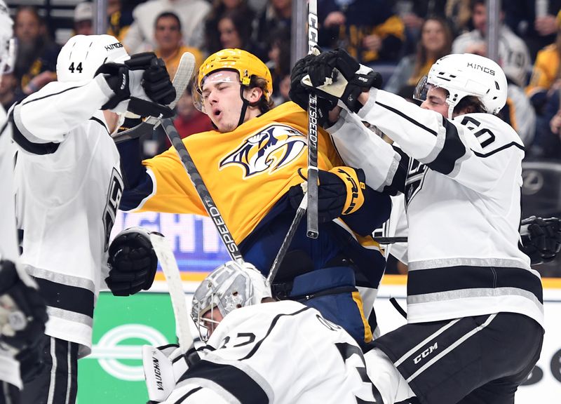 Jan 21, 2023; Nashville, Tennessee, USA; Nashville Predators center Cody Glass (8) is hit by Los Angeles Kings defenseman Sean Durzi (50) after the whistle during the first period at Bridgestone Arena. Mandatory Credit: Christopher Hanewinckel-USA TODAY Sports