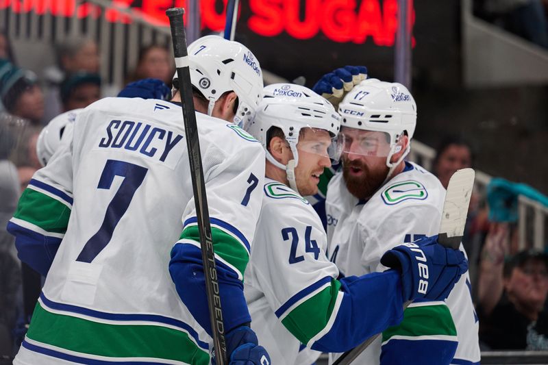 Nov 2, 2024; San Jose, California, USA; Vancouver Canucks center Pius Suter (24) celebrates with defensemen Carson Soucy (7) and Filip Hronek (17) after scoring the game-winning goal against the San Jose Sharks during the third period at SAP Center at San Jose. Mandatory Credit: Robert Edwards-Imagn Images