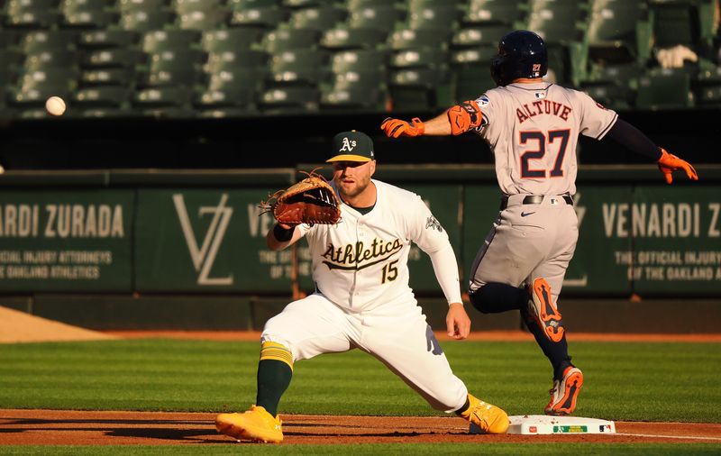 Jul 22, 2024; Oakland, California, USA; Houston Astros second baseman Jose Altuve (27) safe at first base behind Oakland Athletics first baseman Seth Brown (15) during the first inning at Oakland-Alameda County Coliseum. Mandatory Credit: Kelley L Cox-USA TODAY Sports