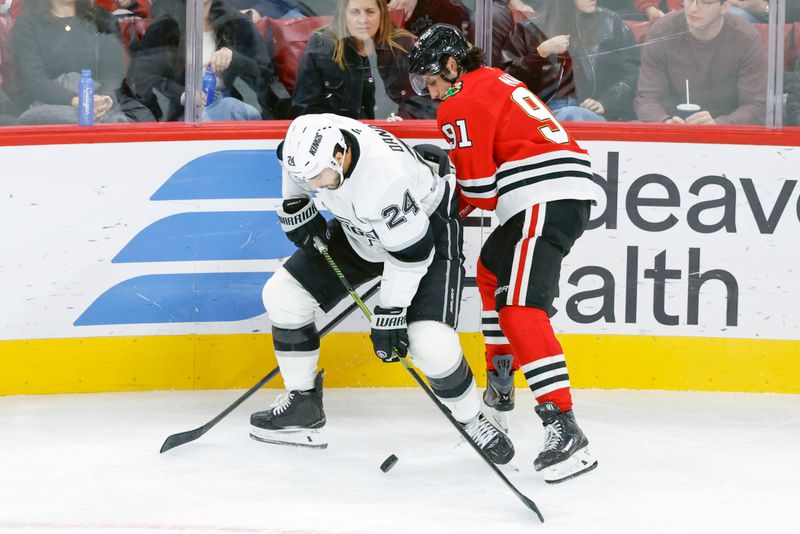 Oct 26, 2025; Chicago, Illinois, USA; Los Angeles Kings center Phillip Danault (24) battles for the puck with Chicago Blackhawks center Frank Nazar (91) during the third period at United Center. Mandatory Credit: Kamil Krzaczynski-Imagn Images
