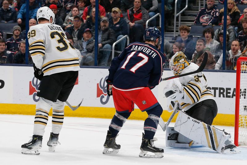 Jan 2, 2024; Columbus, Ohio, USA; Boston Bruins goalie Linus Ullmark (35) makes a save as Columbus Blue Jackets right wing Justin Danforth (17) looks for a rebound during the first period at Nationwide Arena. Mandatory Credit: Russell LaBounty-USA TODAY Sports