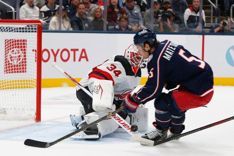 Oct 13, 2025; Columbus, Ohio, USA; New Jersey Devils goalie Jake Allen (34) makes a stick save against the Columbus Blue Jackets during the first period at Nationwide Arena. Mandatory Credit: Russell LaBounty-Imagn Images