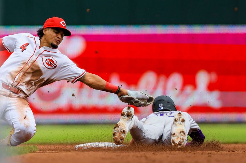 Jul 11, 2024; Cincinnati, Ohio, USA; Cincinnati Reds shortstop Santiago Espinal (4) tags Colorado Rockies designated hitter Nolan Jones (22) out at second on a steal in the third inning at Great American Ball Park. Mandatory Credit: Katie Stratman-USA TODAY Sports