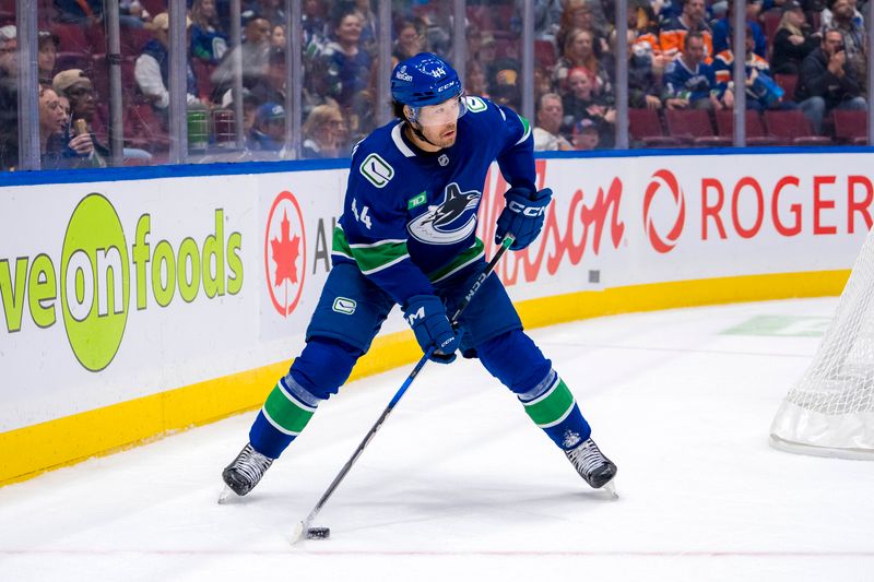 Oct 4, 2024; Vancouver, British Columbia, CAN; Vancouver Canucks forward Kiefer Sherwood (44) handles the puck against the Edmonton Oilers during the third period at Rogers Arena. Mandatory Credit: Bob Frid-Imagn Images