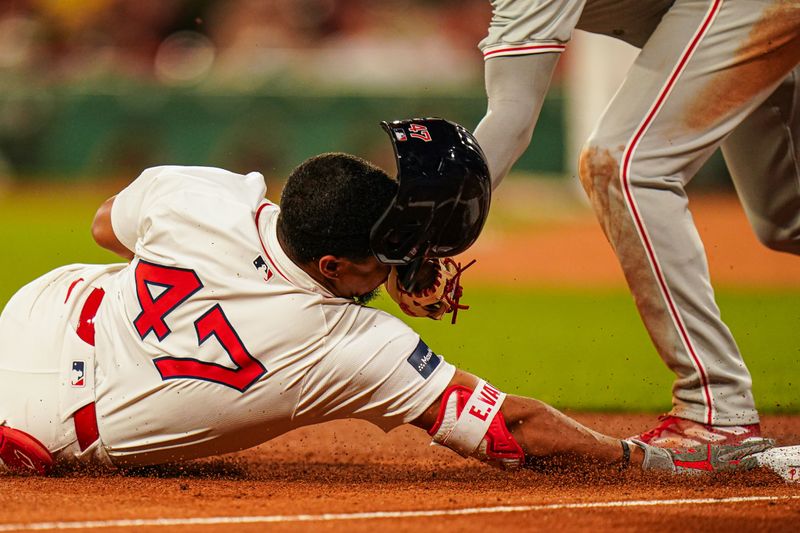 Jun 13, 2024; Boston, Massachusetts, USA; Boston Red Sox second baseman Enmanuel Valdez (47) tagged out at third base by Philadelphia Phillies third baseman Whit Merrifield (9) in the sixth inning at Fenway Park. Mandatory Credit: David Butler II-USA TODAY Sports