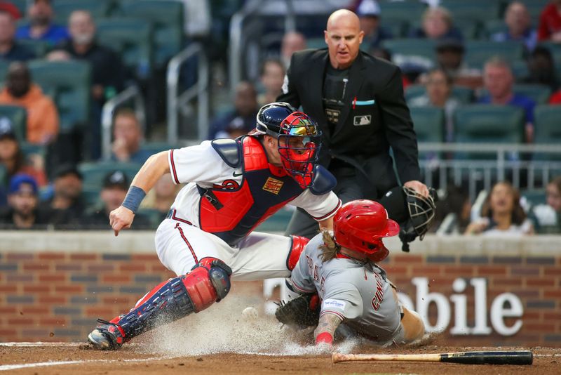 Apr 11, 2023; Atlanta, Georgia, USA; Cincinnati Reds left fielder Jake Fraley (27) slides safely past the tag of Atlanta Braves catcher Sean Murphy (12) in the third inning at Truist Park. Mandatory Credit: Brett Davis-USA TODAY Sports