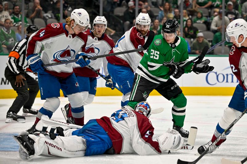 Oct 3, 2022; Dallas, Texas, USA; Colorado Avalanche goaltender Pavel Francouz (39) and defenseman Bowen Byram (4) and right wing Martin Kaut (61) and Dallas Stars left wing Joel Kiviranta (25) look for the loose puck during the second period at the American Airlines Center. Mandatory Credit: Jerome Miron-USA TODAY Sports