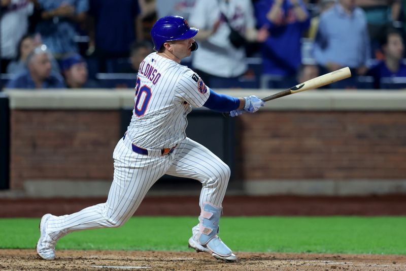 Jun 10, 2025; New York City, New York, USA; New York Mets first baseman Pete Alonso (20) follows through on a game-tying RBI single against the Washington Nationals during the eighth inning at Citi Field. Mandatory Credit: Brad Penner-Imagn Images