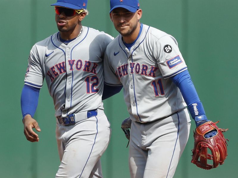 Jul 7, 2024; Pittsburgh, Pennsylvania, USA;  New York Mets shortstop Francisco Lindor (12) and second baseman Jose Iglesias (11) celebrate after defeating the Pittsburgh Pirates at PNC Park. The Mets won 3-2. Mandatory Credit: Charles LeClaire-USA TODAY Sports