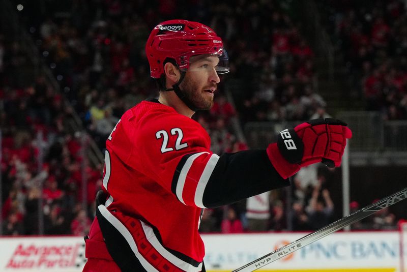 Jan 13, 2024; Raleigh, North Carolina, USA;  Carolina Hurricanes defenseman Brett Pesce (22) scores a goal against the Pittsburgh Penguins during the first period at PNC Arena. Mandatory Credit: James Guillory-USA TODAY Sports