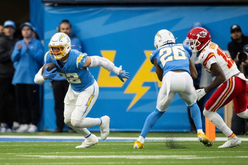 Los Angeles Chargers safety Alohi Gilman (32) runs with the ball after intercepting a pass during an NFL football game against the Kansas City Chiefs, Sunday, Jan. 7, 2024, in Inglewood, Calif. (AP Photo/Kyusung Gong)