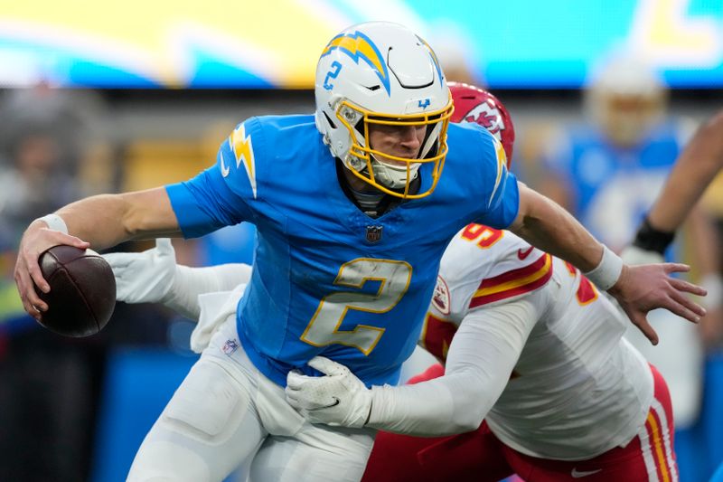 Los Angeles Chargers quarterback Easton Stick (2) is tackled by Kansas City Chiefs defensive end Malik Herring (94) during an NFL football game Monday, Jan. 8, 2024, in Inglewood, Calif. (AP Photo/Ashley Landis)