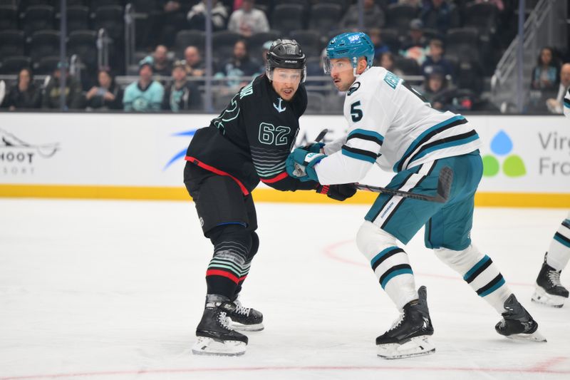 Nov 5, 2025; Seattle, Washington, USA; Seattle Kraken defenseman Brandon Montour (62) and San Jose Sharks defenseman Vincent Desharnais (5) during the second period at Climate Pledge Arena. Mandatory Credit: Steven Bisig-Imagn Images