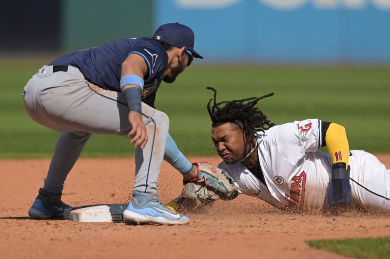 Sep 15, 2024; Cleveland, Ohio, USA; Tampa Bay Rays shortstop Jose Caballero (7) tags out Cleveland Guardians designated hitter Jose Ramirez (11) while stealing during the fifth inning at Progressive Field. Mandatory Credit: Ken Blaze-Imagn Images