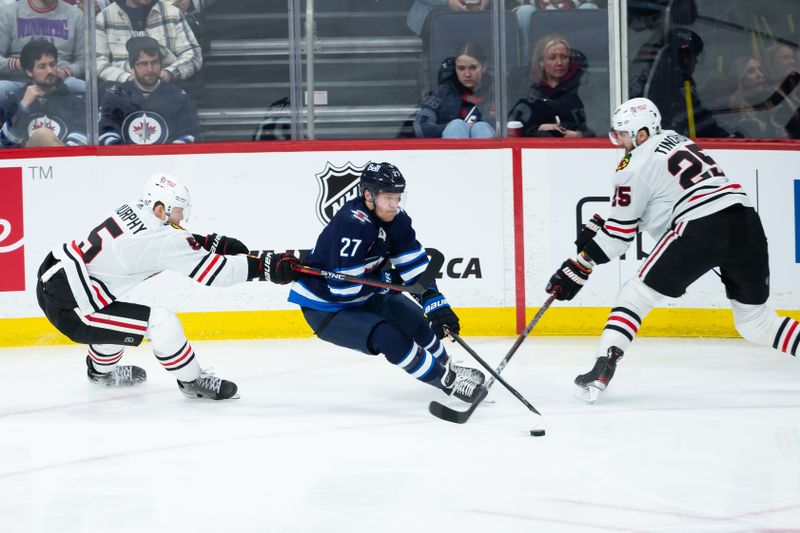 Jan 11, 2024; Winnipeg, Manitoba, CAN; Winnipeg Jets forward Nikolaj Ehlers (27) skies between Chicago Blackhawks defenseman Connor Murphy (5) and Chicago Blackhawks defenseman Jarred Tinordi (25) during the third period at Canada Life Centre. Mandatory Credit: Terrence Lee-USA TODAY Sports