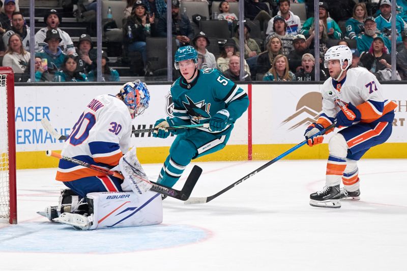 Mar 7, 2026; San Jose, California, USA; New York Islanders goaltender Ilya Sorokin (30) makes a save and defenseman Tony DeAngelo (77) defends against San Jose Sharks right wing Collin Graf (51) during the second period at SAP Center at San Jose. Mandatory Credit: Robert Edwards-Imagn Images