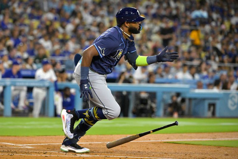 Aug 23, 2024; Los Angeles, California, USA;  Tampa Bay Rays shortstop Junior Caminero (13) doubles in the fourth inning against the Los Angeles Dodgers at Dodger Stadium. Mandatory Credit: Jayne Kamin-Oncea-USA TODAY Sports