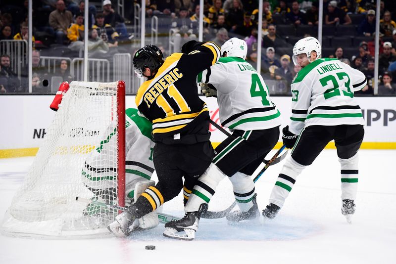 Oct 24, 2024; Boston, Massachusetts, USA;  Boston Bruins center Trent Frederic (11) and Dallas Stars defenseman Ilya Lyubushkin (46) battle in front of goaltender Casey DeSmith (1) during the third period at TD Garden. Mandatory Credit: Bob DeChiara-Imagn Images