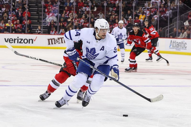 Mar 7, 2023; Newark, New Jersey, USA; Toronto Maple Leafs center Auston Matthews (34) skates with the puck against the New Jersey Devils during the second period at Prudential Center. Mandatory Credit: Ed Mulholland-USA TODAY Sports