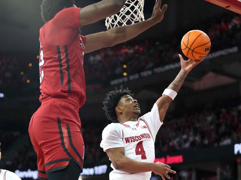 Mar 7, 2024; Madison, Wisconsin, USA; Wisconsin Badgers guard Kamari McGee (4) scores against Rutgers Scarlet Knights center Emmanuel Ogbole (22) during the second half at the Kohl Center. Mandatory Credit: Kayla Wolf-USA TODAY Sports