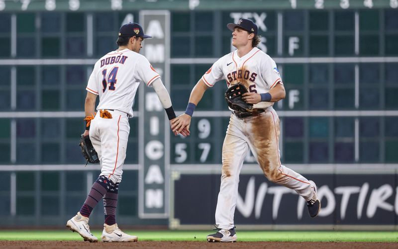 Jul 4, 2023; Houston, Texas, USA; Houston Astros second baseman Mauricio Dubon (14) and center fielder Jake Meyers (6) celebrate after the game against the Colorado Rockies at Minute Maid Park. Mandatory Credit: Troy Taormina-USA TODAY Sports