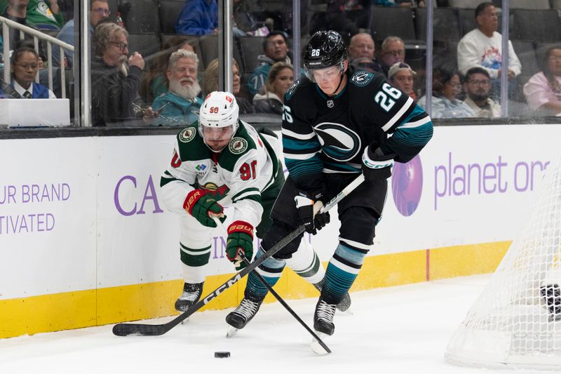 Nov 7, 2024; San Jose, California, USA;  Minnesota Wild center Marcus Johansson (90) and San Jose Sharks defenseman Jack Thompson (26) fight for control of the puck during the first period at SAP Center at San Jose. Mandatory Credit: Stan Szeto-Imagn Images