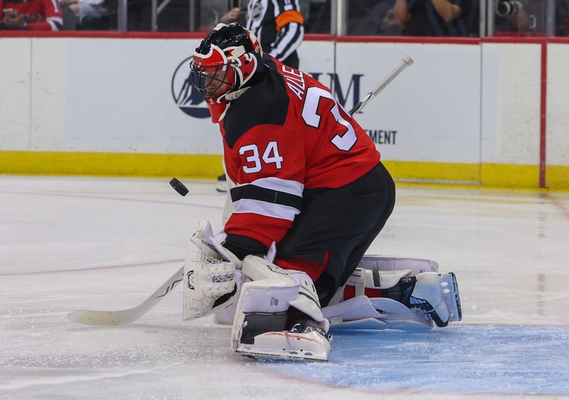 Oct 22, 2024; Newark, New Jersey, USA; New Jersey Devils goaltender Jake Allen (34) makes a save against the Tampa Bay Lightning during the first period at Prudential Center. Mandatory Credit: Ed Mulholland-Imagn Images